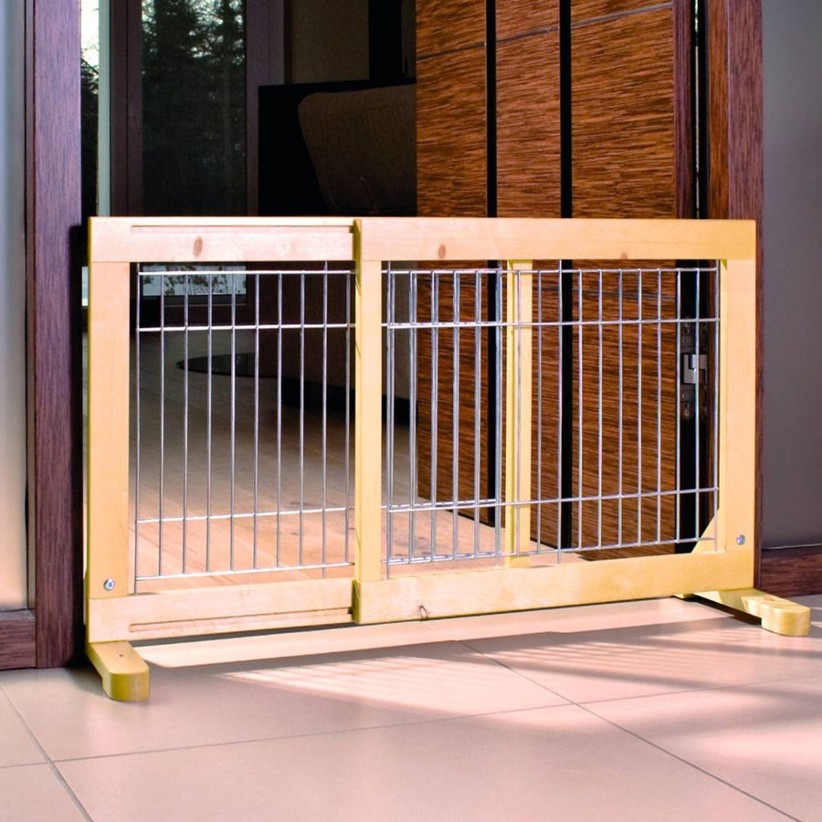 Trixie Pinewood Barrier with Door - A small brown dog safely playing behind a stylish wooden pet gate with a clear varnish finish and a small built-in door