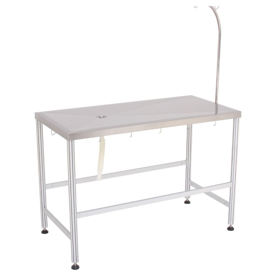 Stainless-Steel Veterinary Examination Table: A veterinarian comfortably examining a pet on the stainless-steel tabletop of the Aeolus FT-870L Omega Consulting Table. (Stainless-Steel Tabletop, Veterinary Examination Table) - ABK Grooming